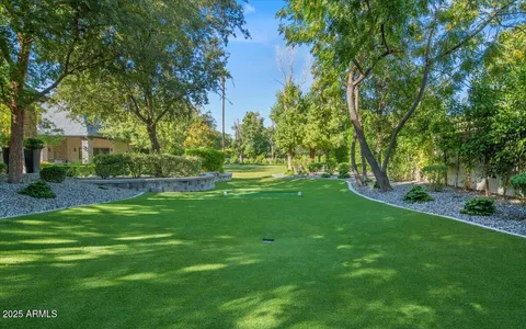 an aerial view of a house with yard swimming pool and outdoor seating