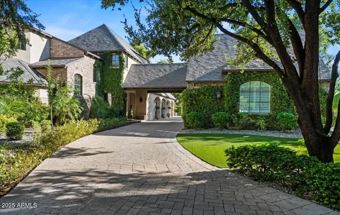a view of a house with garden and trees