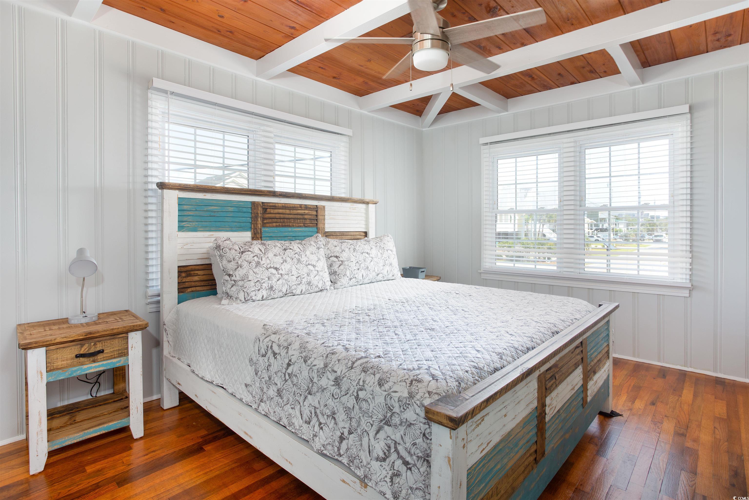 214 Yucca Avenue Murrells Inlet, SC 29576 - Photo 16 of 22 Bedroom featuring dark wood-type flooring, ceiling fan, and a wood ceiling with exposed beams