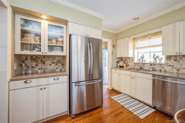 a kitchen with a dining table chairs and window