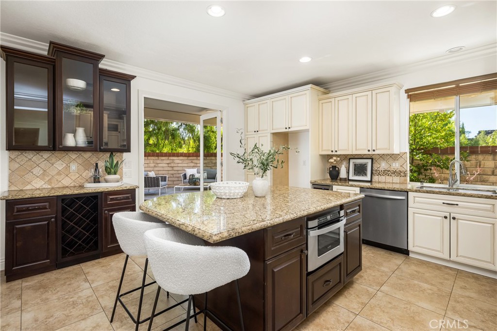 10970 Hiskey Lane Tustin, CA 92782 - Photo 23 of 60 a kitchen with a stove a sink and a refrigerator