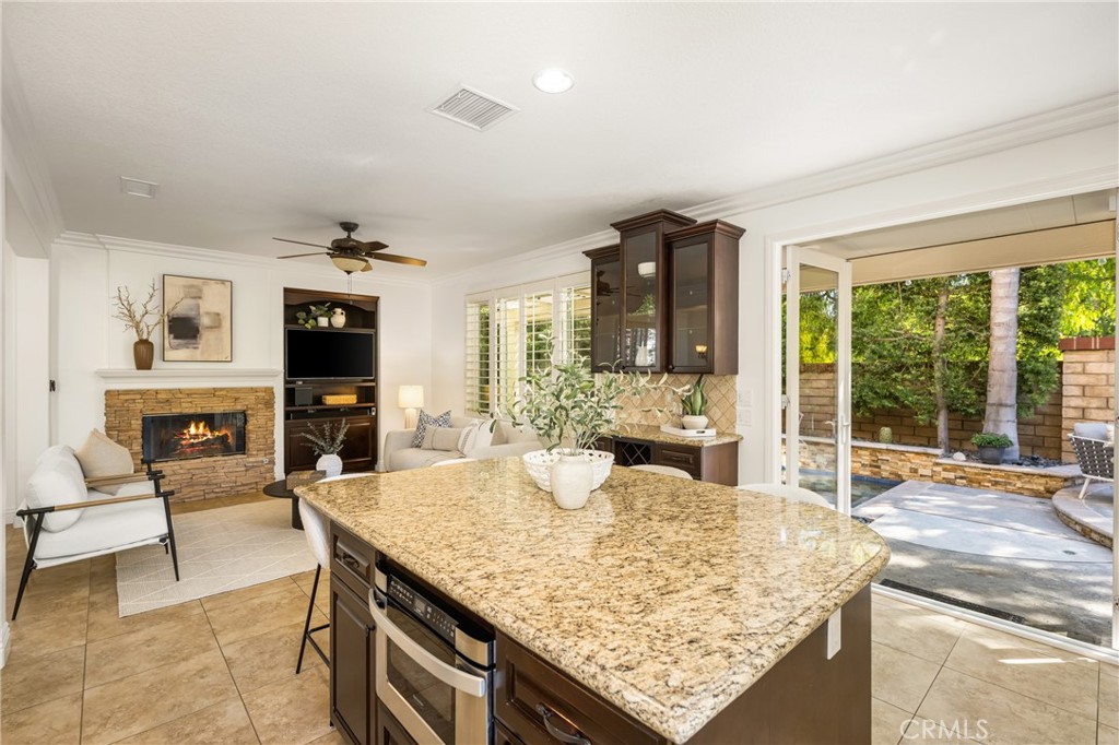 10970 Hiskey Lane Tustin, CA 92782 - Photo 28 of 60 a living room with fireplace furniture and a floor to ceiling window