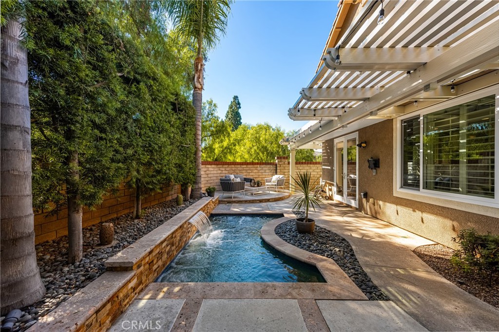 10970 Hiskey Lane Tustin, CA 92782 - Photo 33 of 60 a view of a patio with table and chairs and potted plants