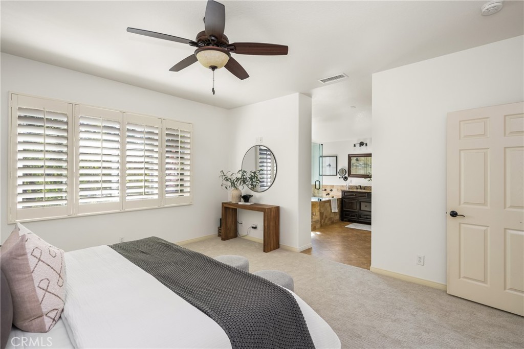 10970 Hiskey Lane Tustin, CA 92782 - Photo 43 of 60 a bedroom with a bed a chandelier and a window