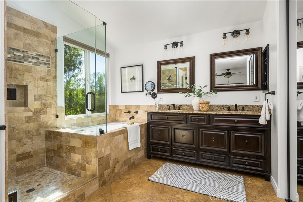 10970 Hiskey Lane Tustin, CA 92782 - Photo 44 of 60 a spacious bathroom with a granite countertop tub sink and mirror