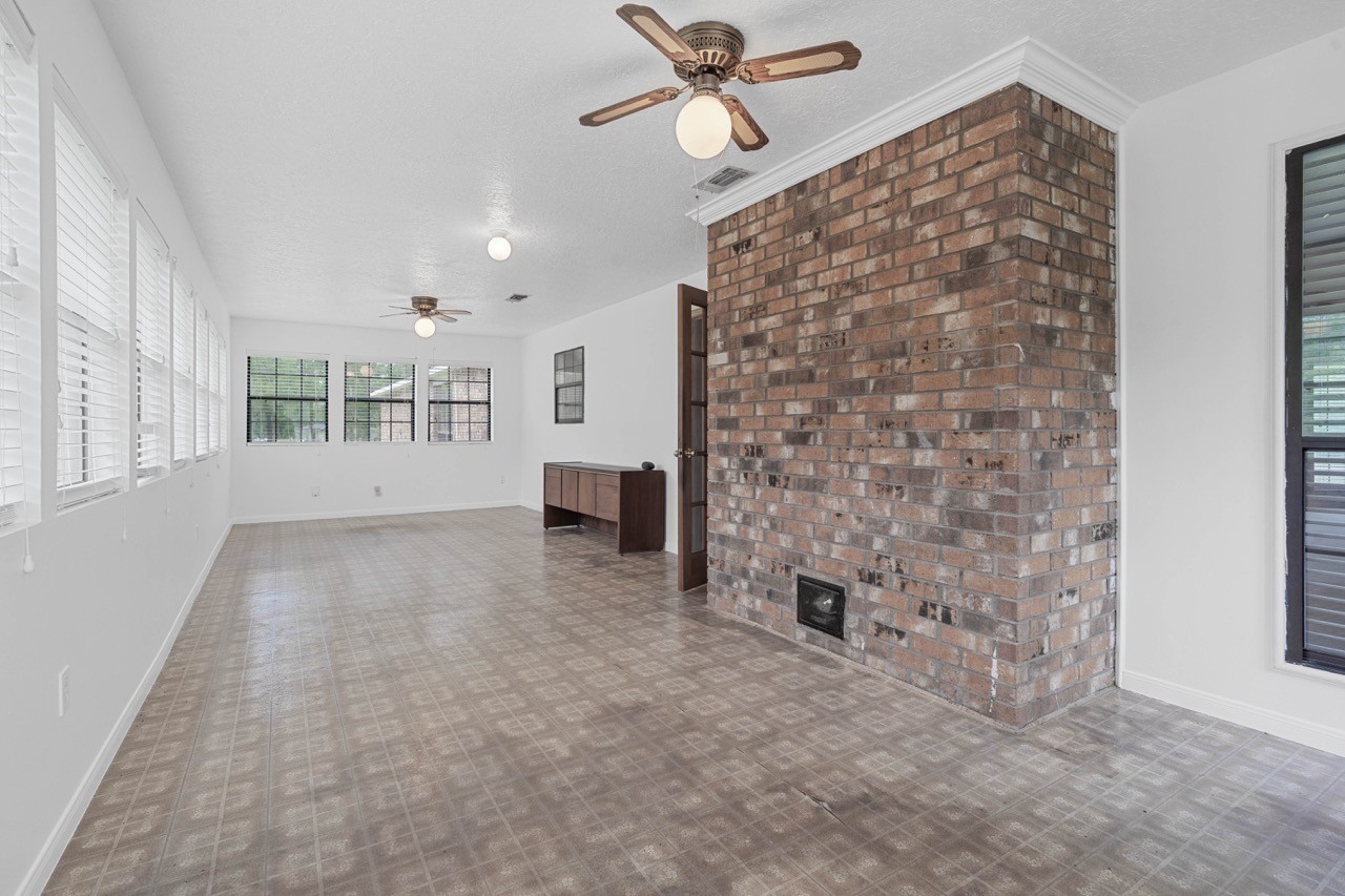 13180 Morgan Drive Splendora, TX 77372 - Photo 15 of 38 Picture yourself in this sunroom relaxing with a glass of sweet tea. Turn this into a family room to gather in the evenings. Plenty of room to host gatherings. Door to the right leads to the living room.