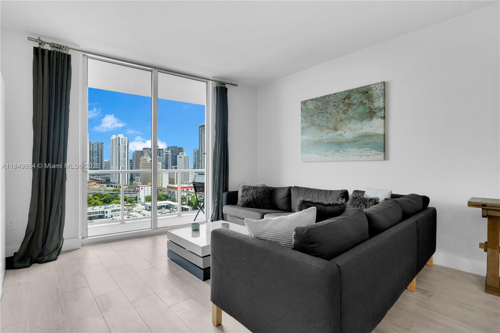 185 Southwest 7th Street, Unit 1901 Miami, FL 33130 - Photo 11 of 46 a living room with furniture and a large window
