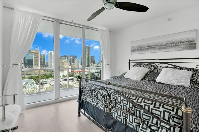 a bedroom with a bed and glass window