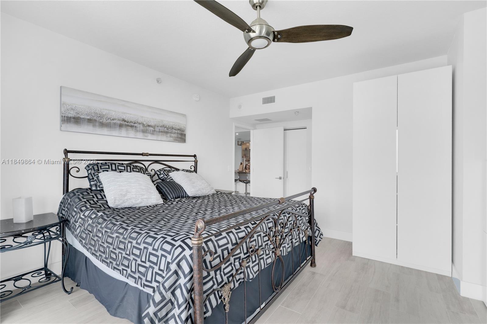 185 Southwest 7th Street, Unit 1901 Miami, FL 33130 - Photo 17 of 46 a bedroom with a large bed and a chandelier