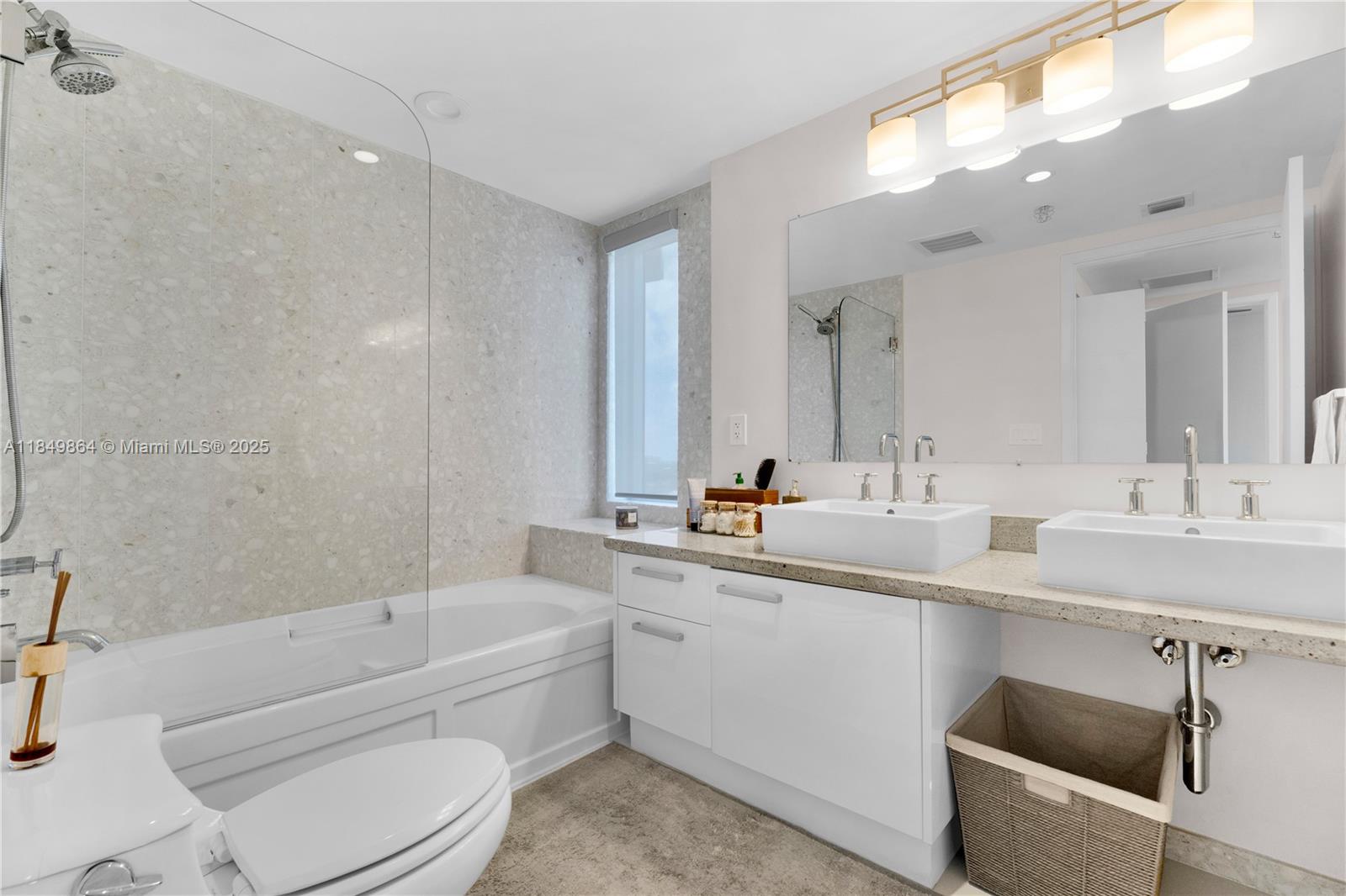 185 Southwest 7th Street, Unit 1901 Miami, FL 33130 - Photo 20 of 46 a bathroom with a bathtub shower sink mirror and toilet