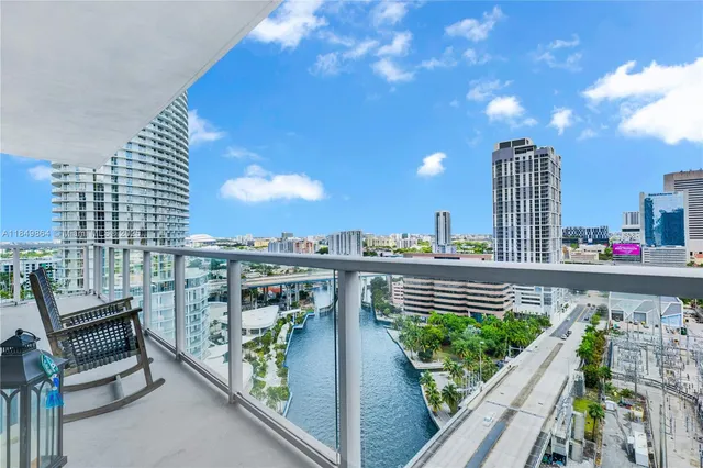 a view of roof deck with outdoor seating and city view