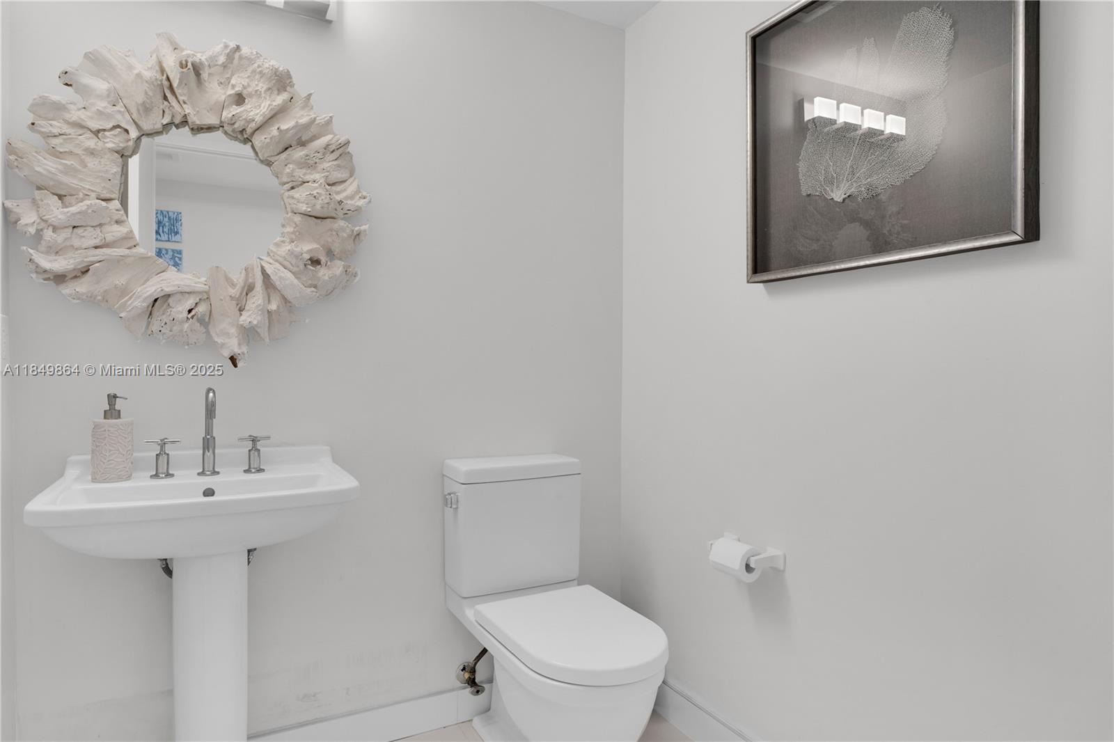 185 Southwest 7th Street, Unit 1901 Miami, FL 33130 - Photo 21 of 46 a bathroom with a toilet a sink and mirror