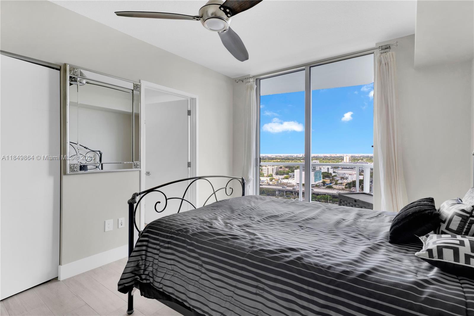 185 Southwest 7th Street, Unit 1901 Miami, FL 33130 - Photo 23 of 46 a bedroom with a bed and window