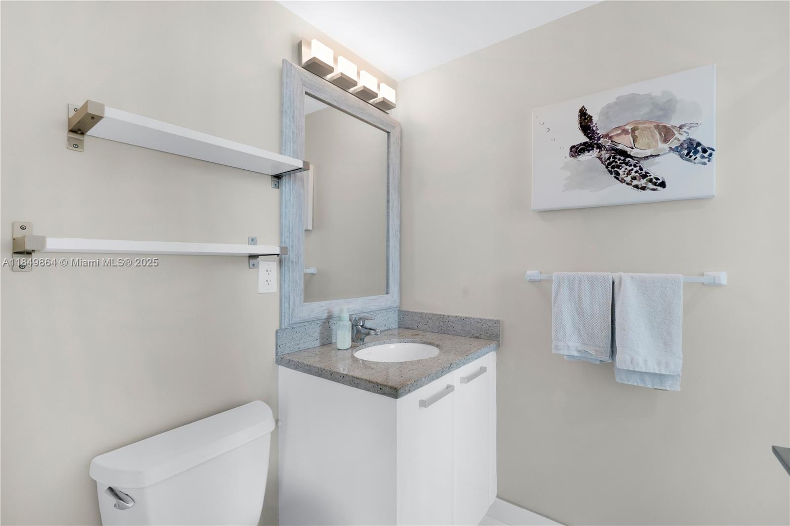 185 Southwest 7th Street, Unit 1901 Miami, FL 33130 - Photo 25 of 46 a bathroom with a toilet sink and mirror
