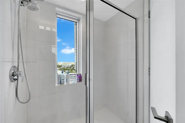 a bathroom with a glass shower door