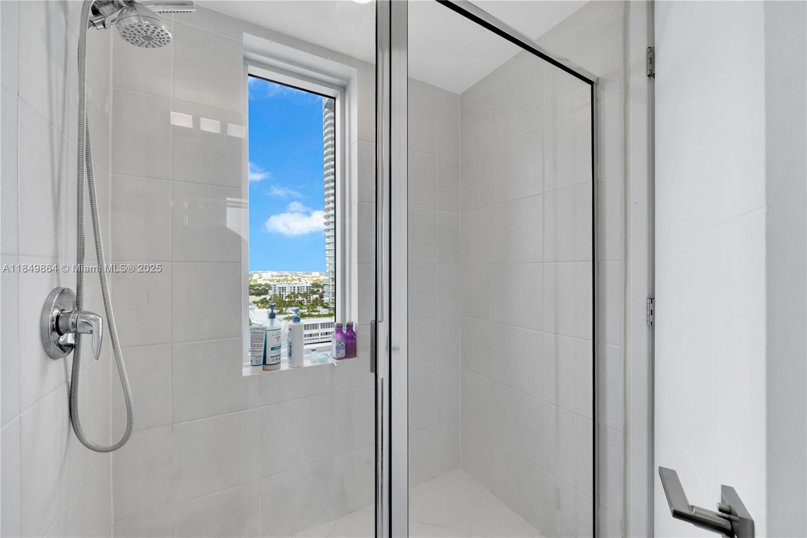 185 Southwest 7th Street, Unit 1901 Miami, FL 33130 - Photo 26 of 46 a bathroom with a glass shower door
