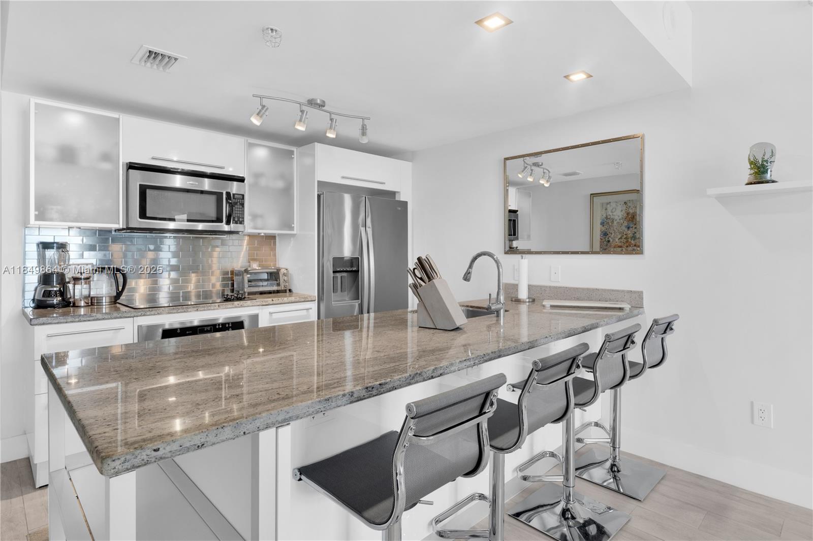 185 Southwest 7th Street, Unit 1901 Miami, FL 33130 - Photo 3 of 46 a kitchen with stainless steel appliances granite countertop a sink refrigerator and microwave