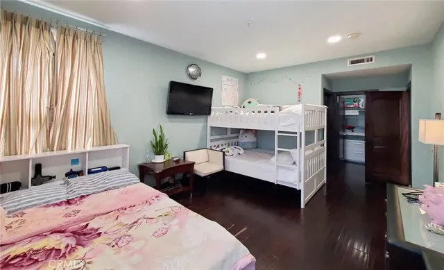 a bedroom with a bed and a large mirror