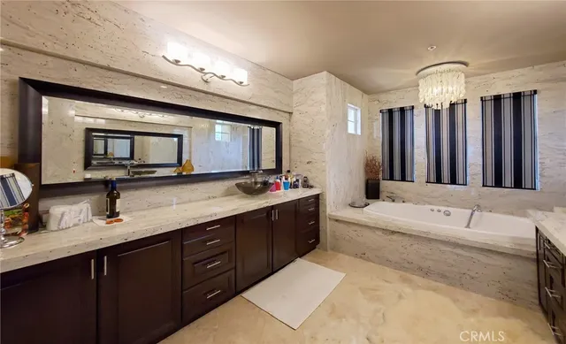 a bathroom with a granite countertop sink mirror and shower