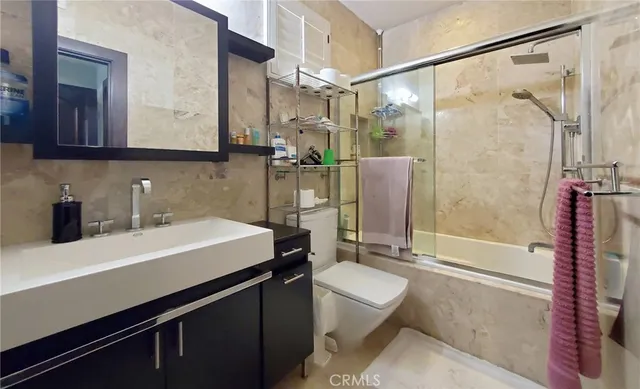 a spacious bathroom with a double vanity sink a mirror and a bathtub