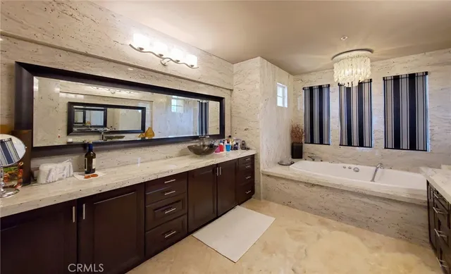 a bathroom with a granite countertop sink mirror and shower