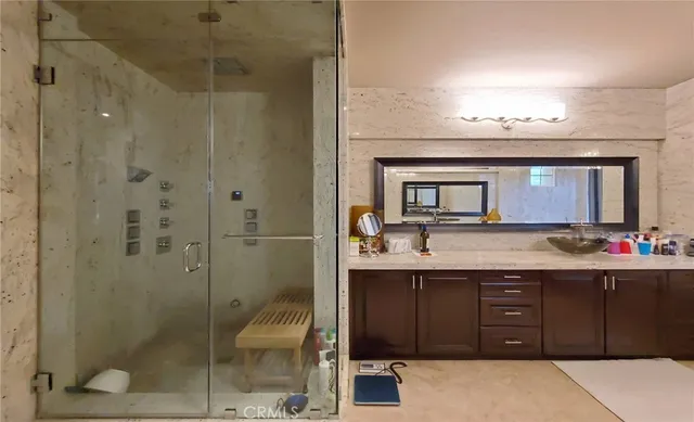 a bathroom with a sink vanity and mirror