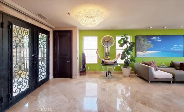 a view of a hallway with windows and chandelier