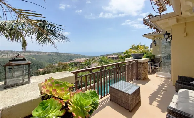a view of a patio with couches and a table and chairs under an umbrella