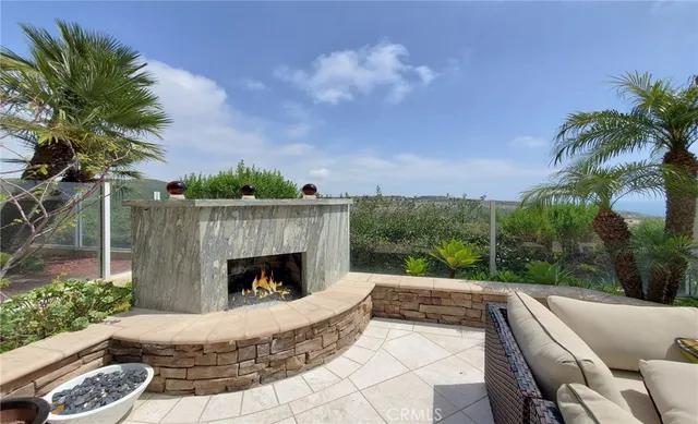 a view of a patio with couches and a table and chairs with wooden floor
