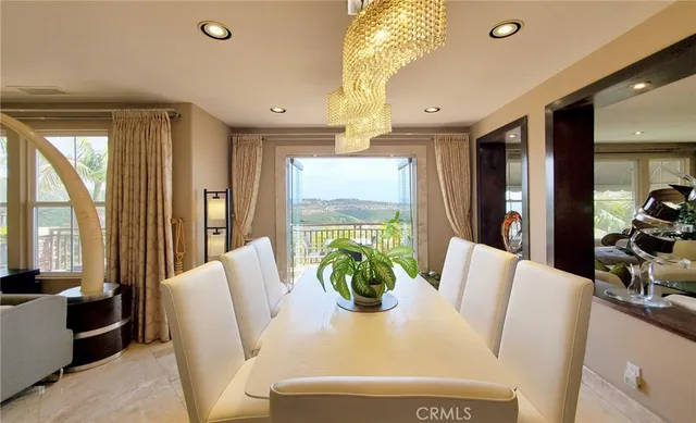 a view of a dining room with furniture wooden floor and chandelier