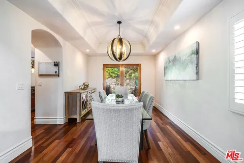 a kitchen with stainless steel appliances granite countertop a stove and wooden cabinets