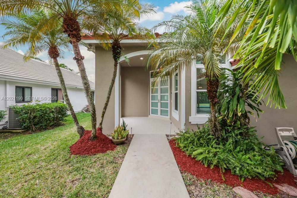 814 Heron Road Weston, FL 33326 - Photo 7 of 27 a front view of a house with garden