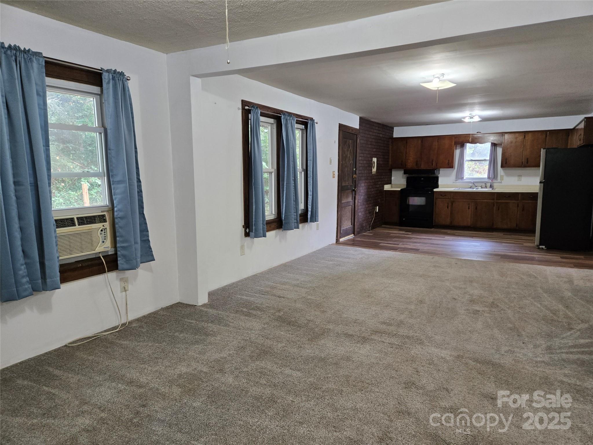148 Huffman Road Clyde, NC 28721 - Photo 11 of 46 a view of an empty room with a fireplace and a window