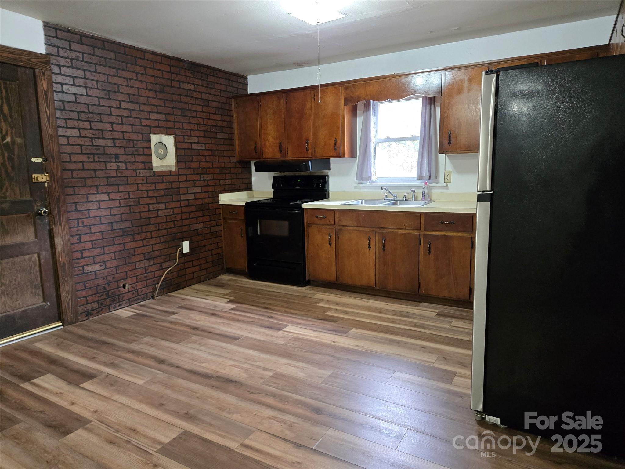 148 Huffman Road Clyde, NC 28721 - Photo 14 of 46 a kitchen with a refrigerator and a stove top oven