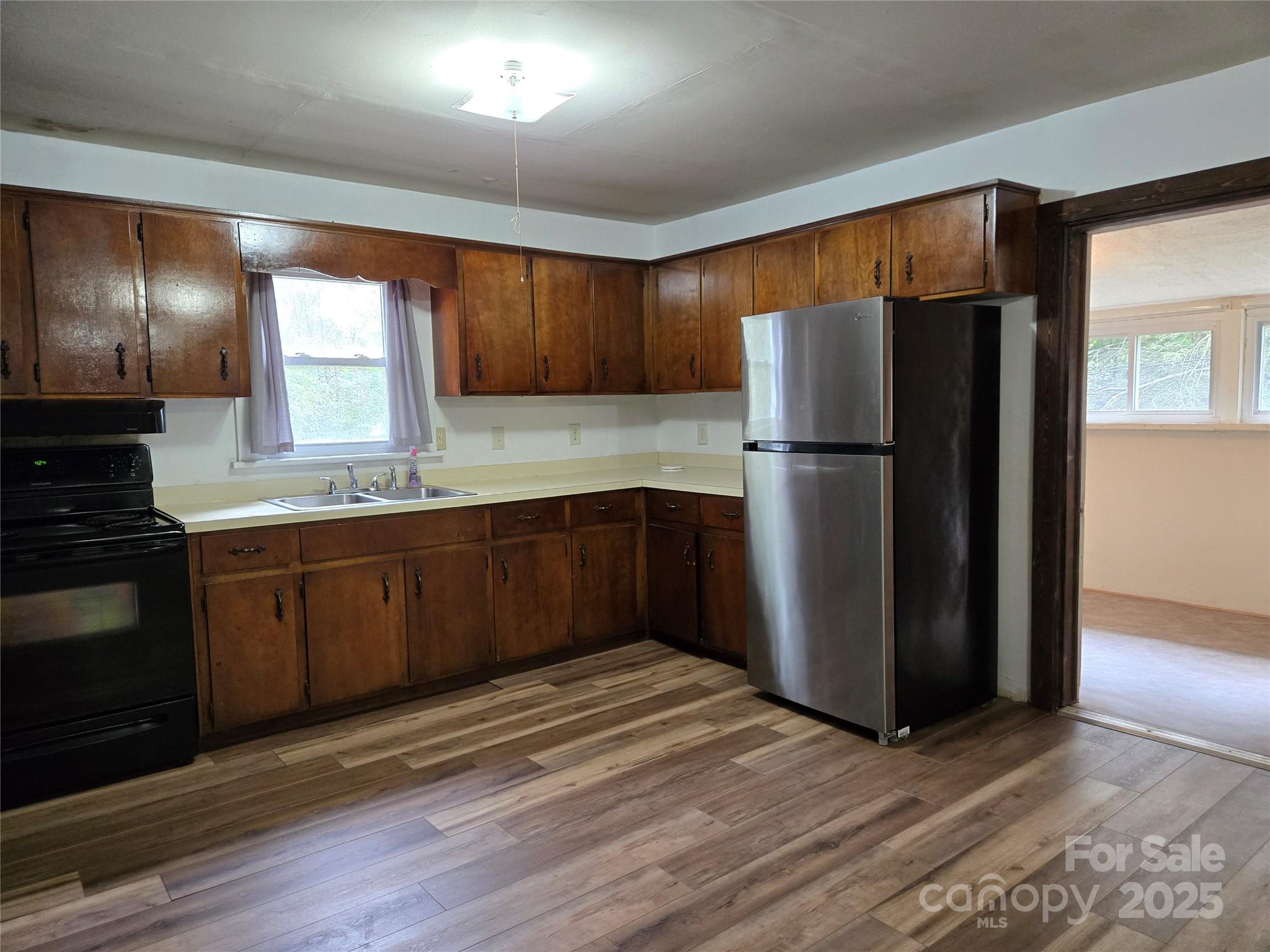 148 Huffman Road Clyde, NC 28721 - Photo 15 of 46 a kitchen with a refrigerator and a sink