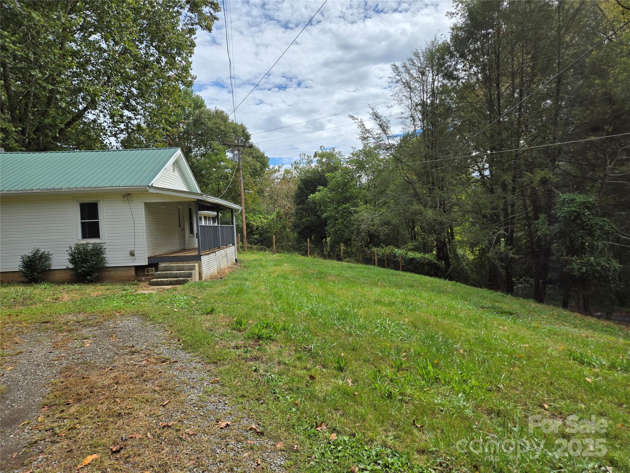148 Huffman Road Clyde, NC 28721 - Photo 2 of 46 a view of a house with backyard and garden