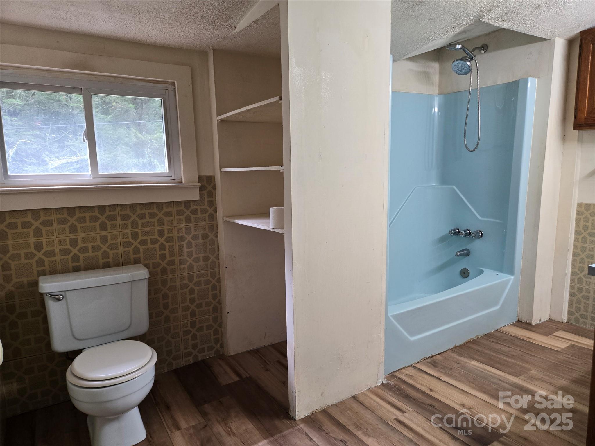 148 Huffman Road Clyde, NC 28721 - Photo 22 of 46 a bathroom with a toilet and a shower