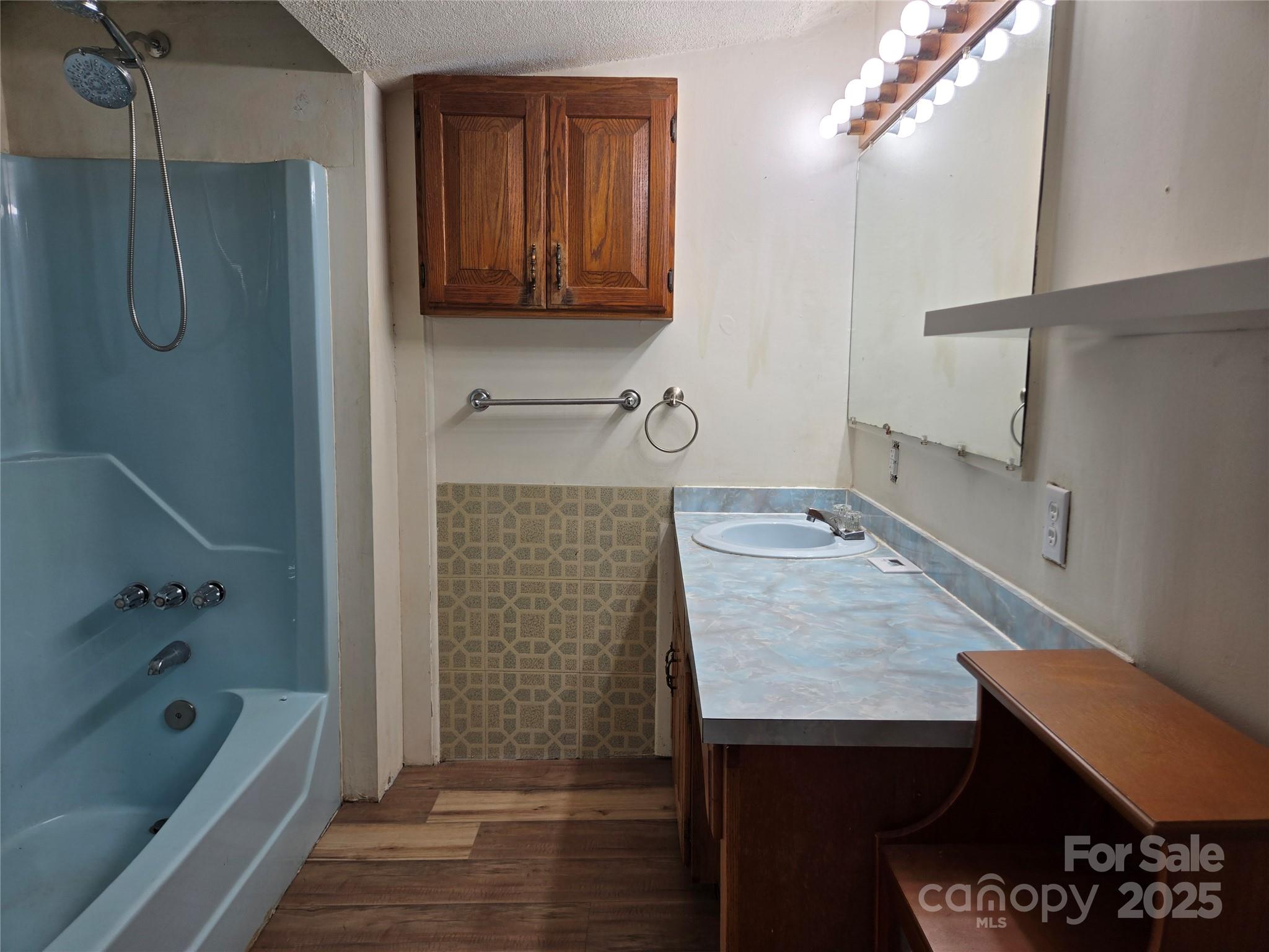 148 Huffman Road Clyde, NC 28721 - Photo 24 of 46 a bathroom with a tub a sink and a shower
