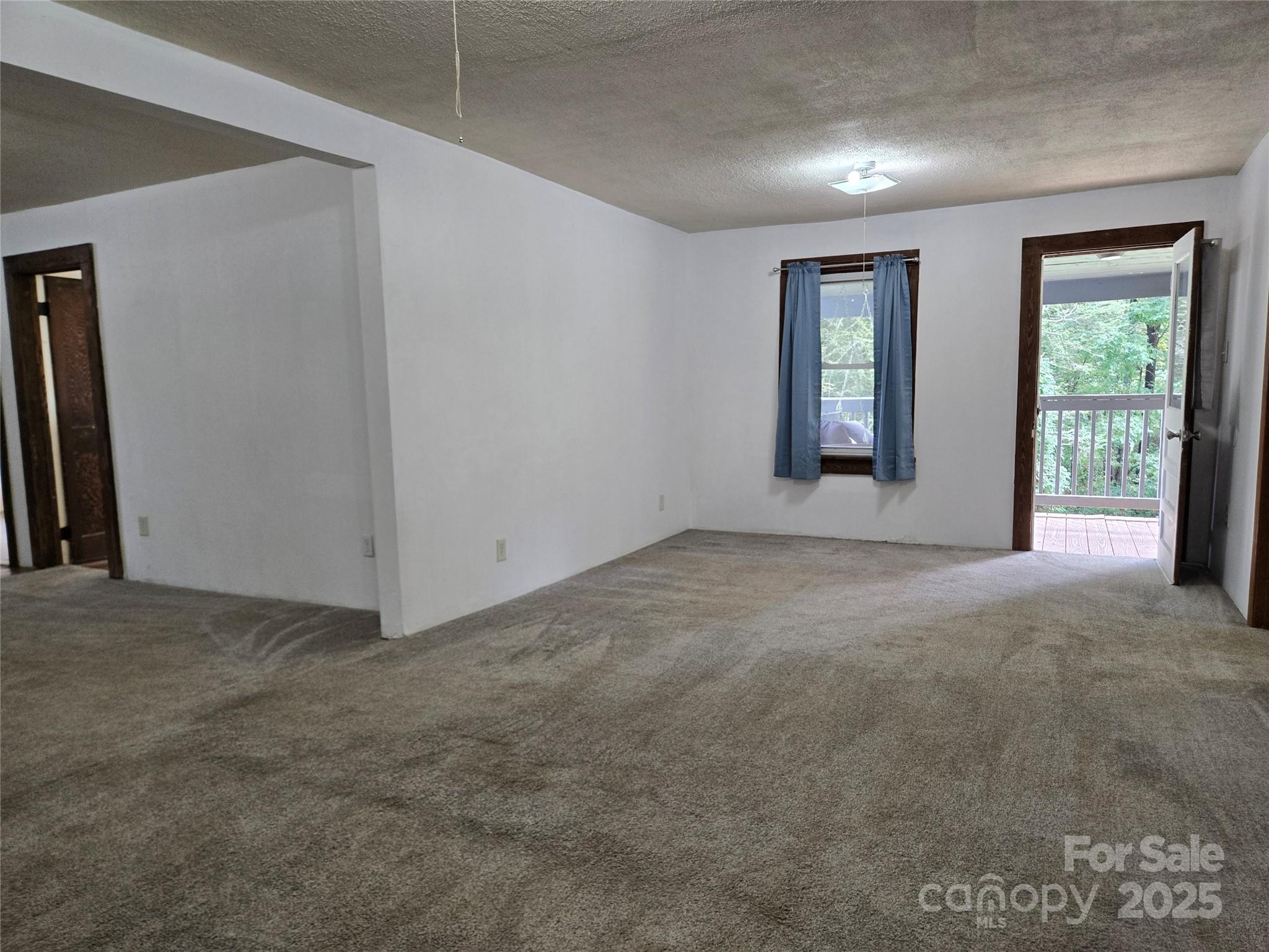 148 Huffman Road Clyde, NC 28721 - Photo 32 of 46 a view of an empty room with windows