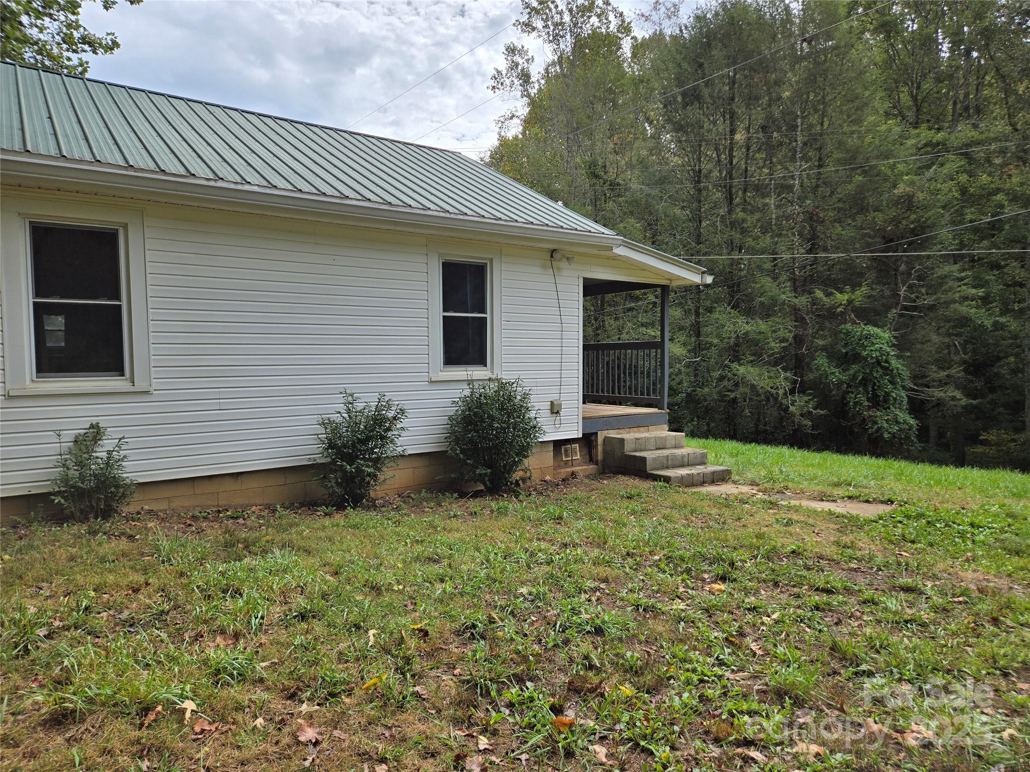 148 Huffman Road Clyde, NC 28721 - Photo 33 of 46 a view of a house with backyard and sitting area