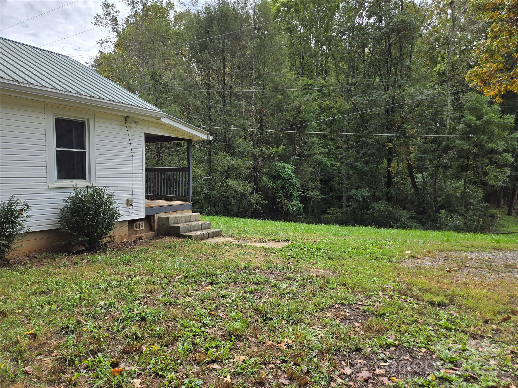 148 Huffman Road Clyde, NC 28721 - Photo 5 of 46 a backyard of a house with plants and garden