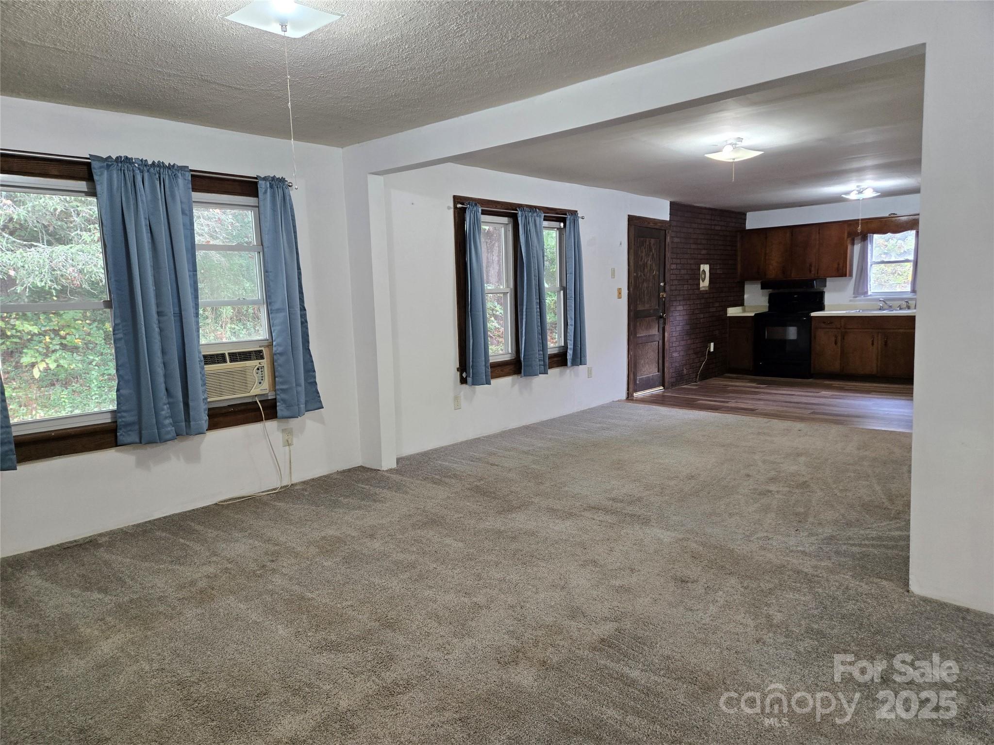 148 Huffman Road Clyde, NC 28721 - Photo 10 of 46 a view of an empty room with window and a kitchen