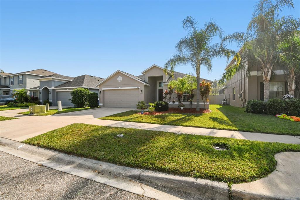 8439 Hunters Fork Loop Ruskin, FL 33573 - Photo 2 of 74 a view of a house with a swimming pool and a yard