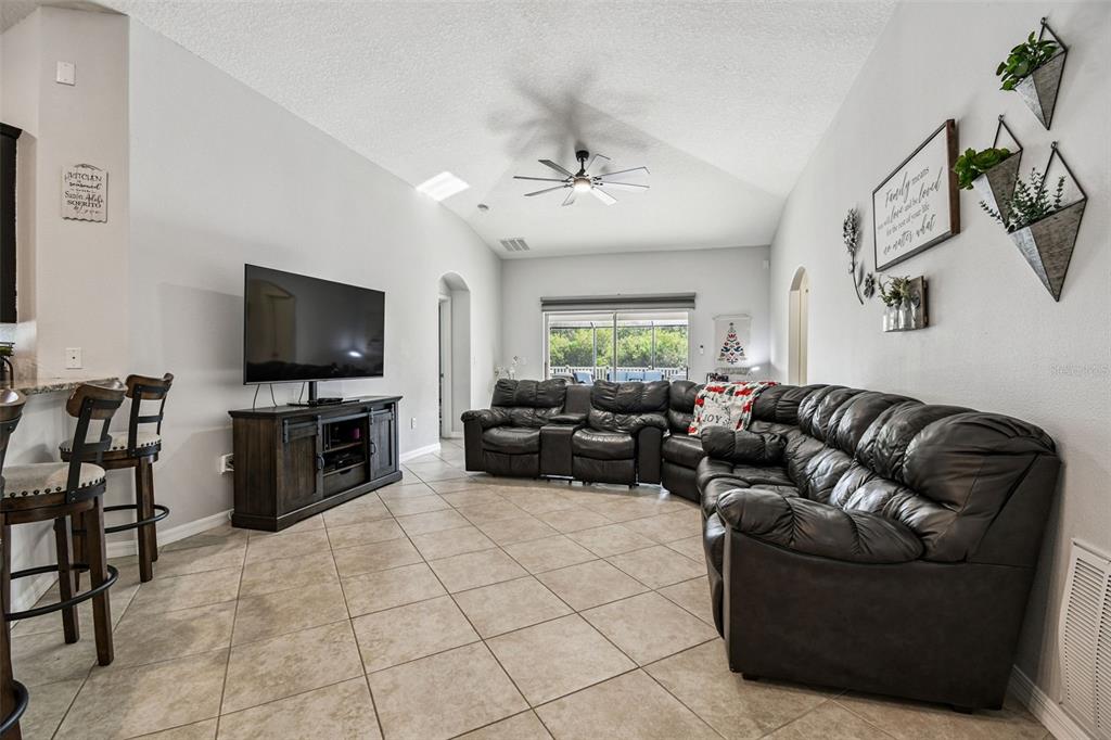 8439 Hunters Fork Loop Ruskin, FL 33573 - Photo 21 of 74 a living room with furniture and a flat screen tv