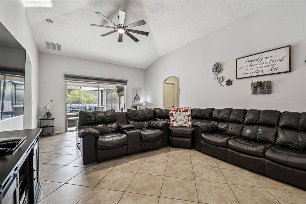 8439 Hunters Fork Loop Ruskin, FL 33573 - Photo 24 of 74 a living room with furniture and a fireplace