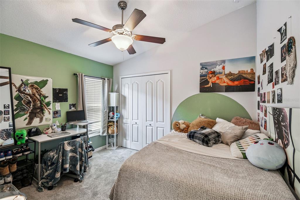 8439 Hunters Fork Loop Ruskin, FL 33573 - Photo 28 of 74 a bedroom with furniture and a chandelier