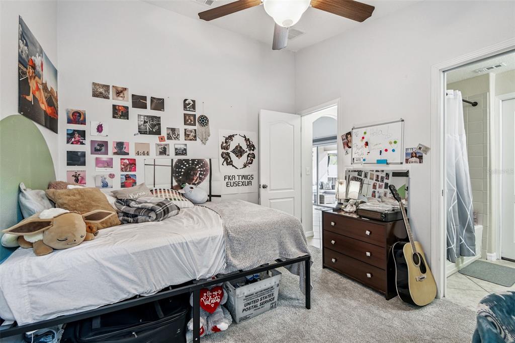 8439 Hunters Fork Loop Ruskin, FL 33573 - Photo 29 of 74 a bedroom with a bed and a walk in closet