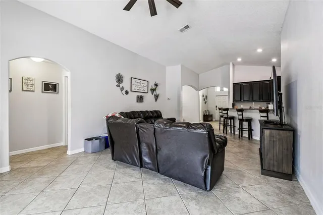 a aerial view of a house next to a yard