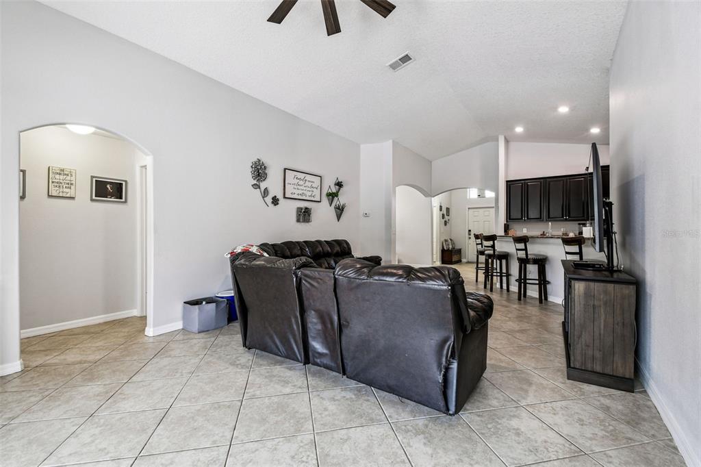 8439 Hunters Fork Loop Ruskin, FL 33573 - Photo 39 of 74 a living room with furniture and a flat screen tv