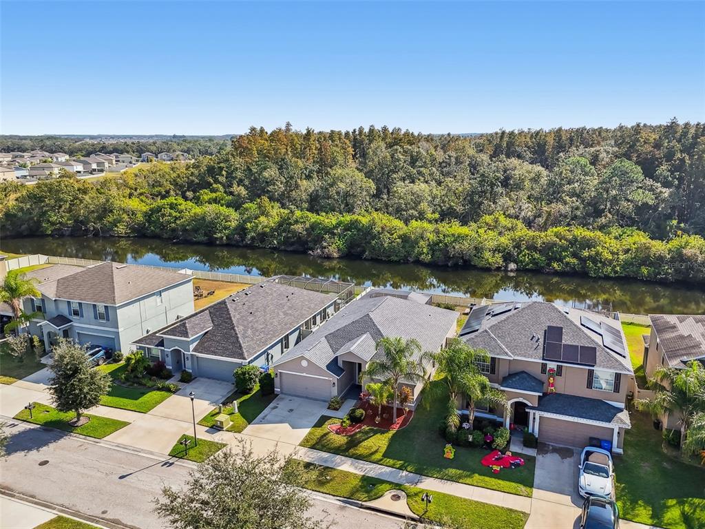 8439 Hunters Fork Loop Ruskin, FL 33573 - Photo 59 of 74 an aerial view of residential houses with outdoor space and lake view